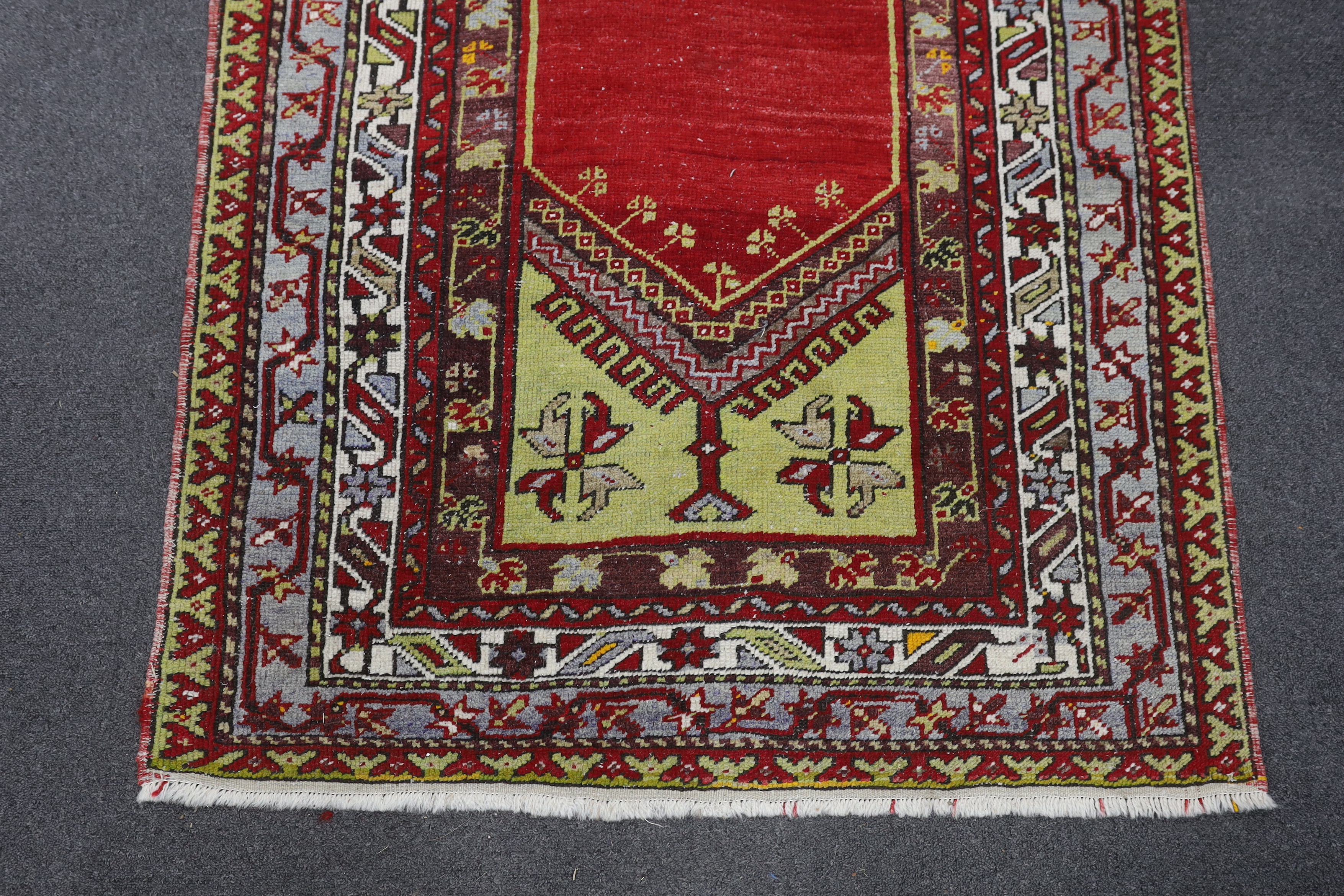 A Kesimuhsine Konya red ground prayer rug, 194 x 104cm